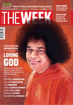 Magazine cover featuring a person with text about Sathya Sai Baba on an orange background