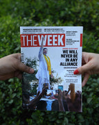 Two people holding The Week magazine together outdoors featuring Bihar elections cover story