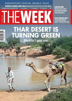 Cover of 'The Week' magazine featuring a desert scene with camels and a person by a water source.